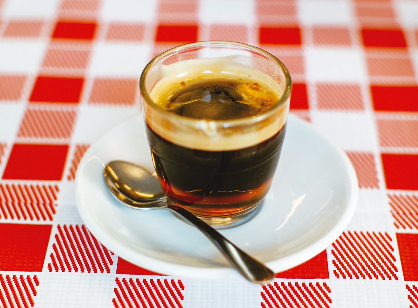 A cremaet served on a red-white checkered table cloth