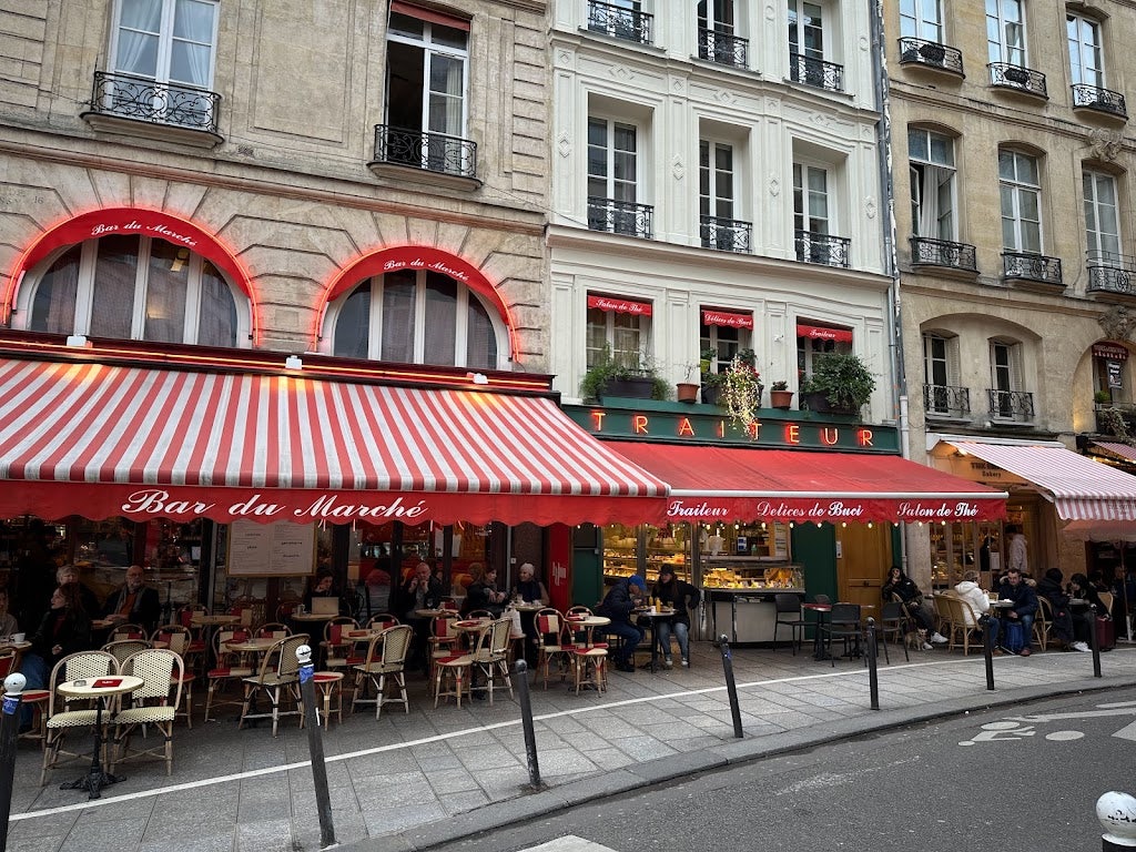 a vibrant red-coloured terrace at the Bar du Marché in Paris