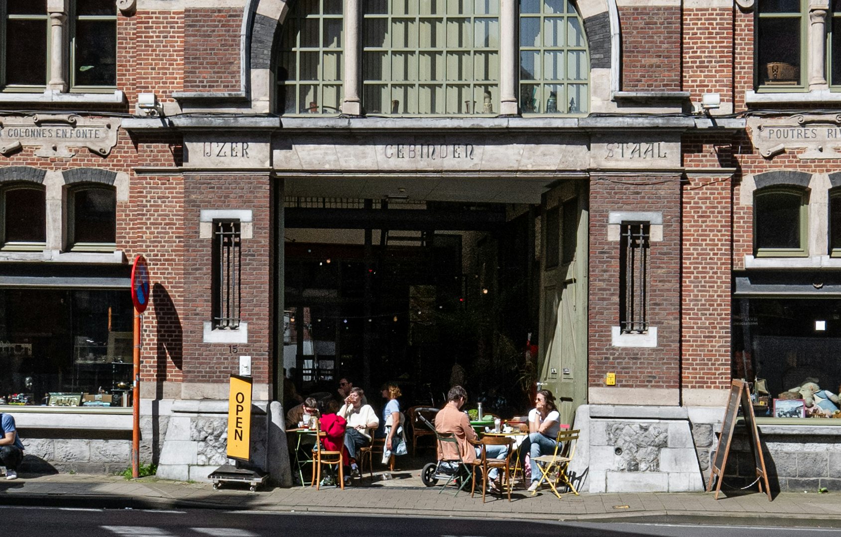 people sitting outside on the terrace of the Antiek-Depot Ghent