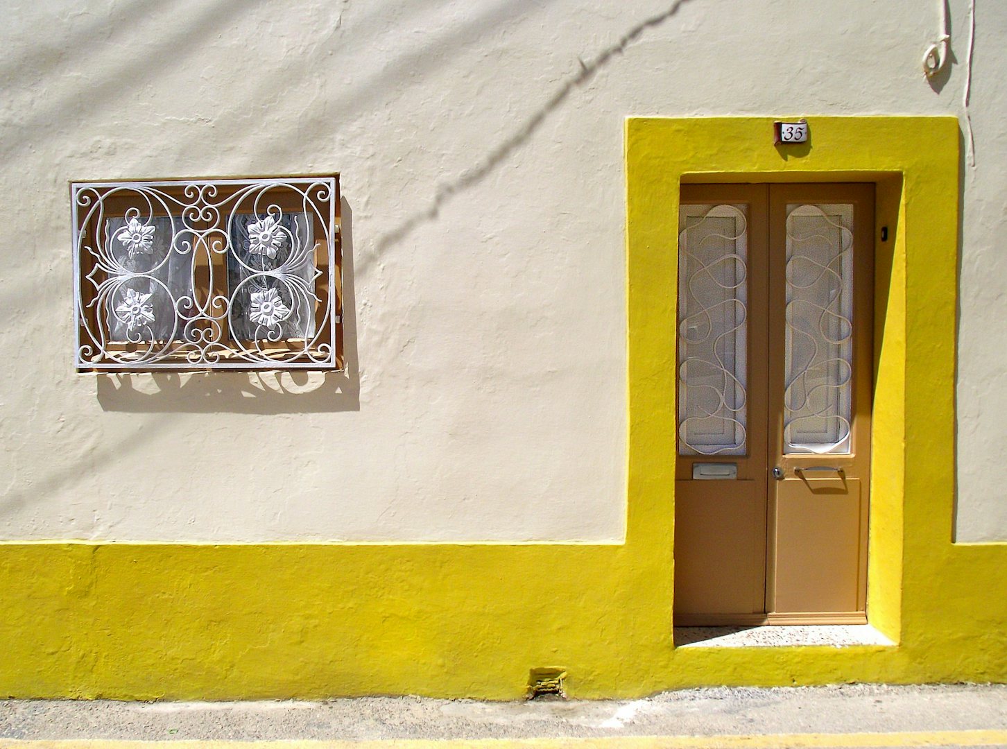 a cuty yellow-coloured house front in Naxxar Malta
