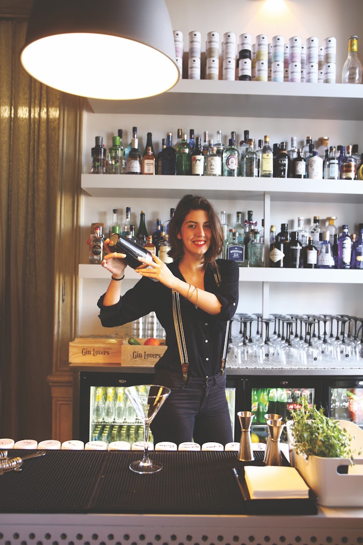 a woman shaking a cocktail shaker
