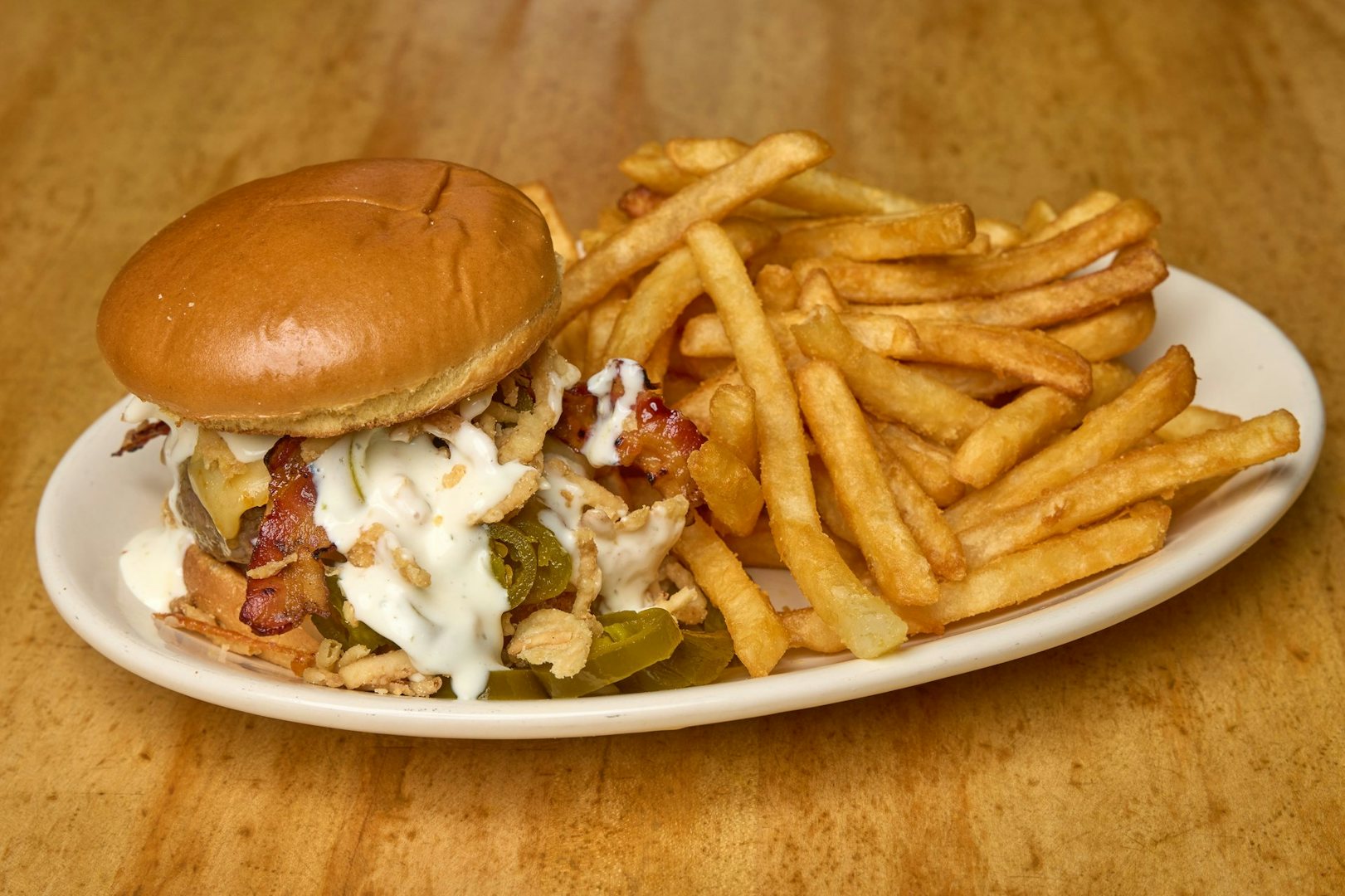 a delicious burger and fries on a plate from Bartley's Boston