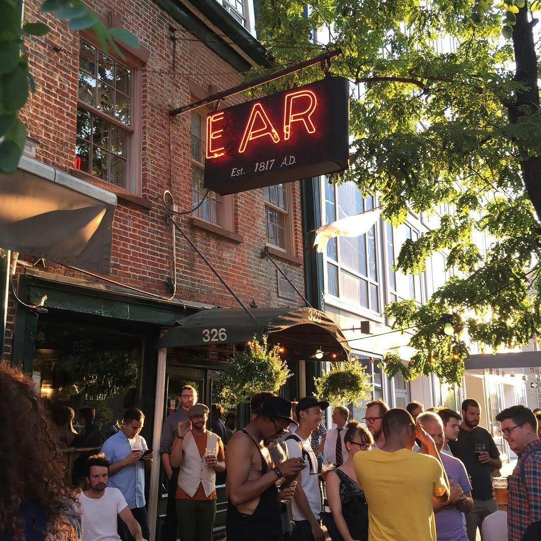 people enjoying a drink outside the Ear Inn in NYC
