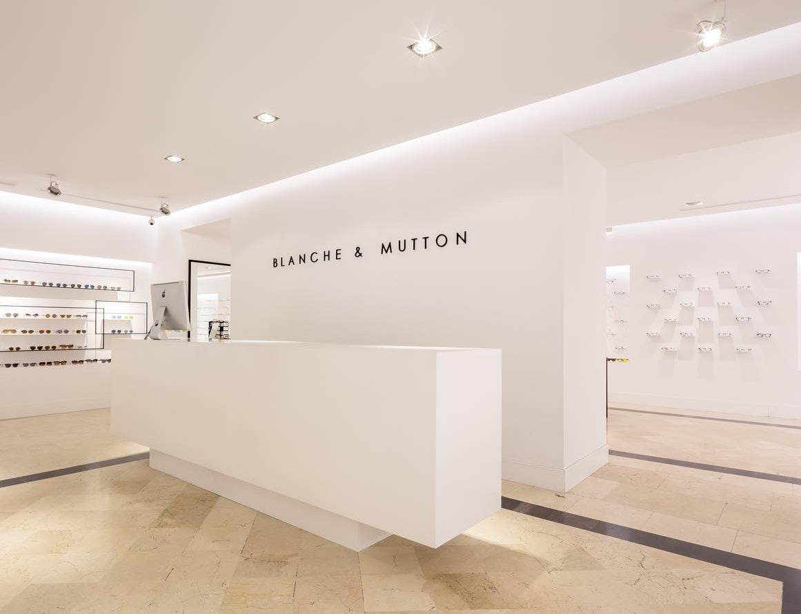 sleek white interior of Blanche & Mutton shop in Madrid