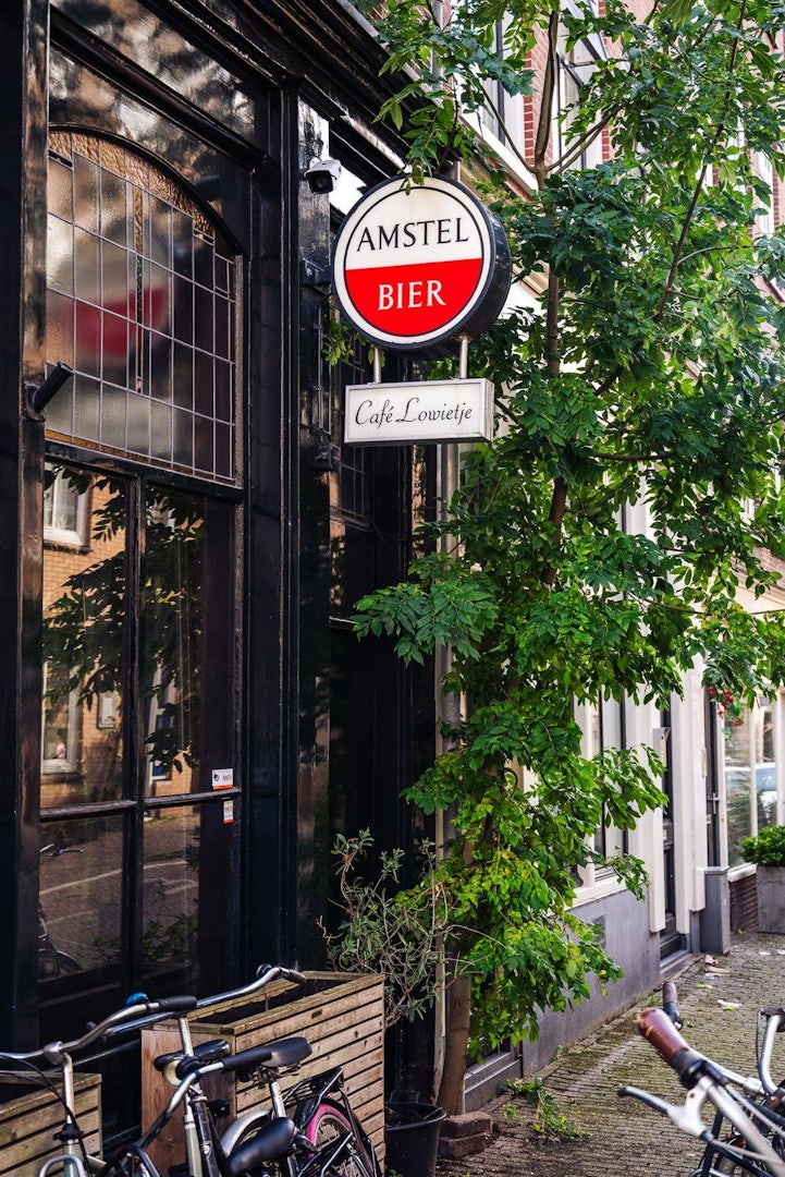 a green exterior of Café Lowietje in Amsterdam