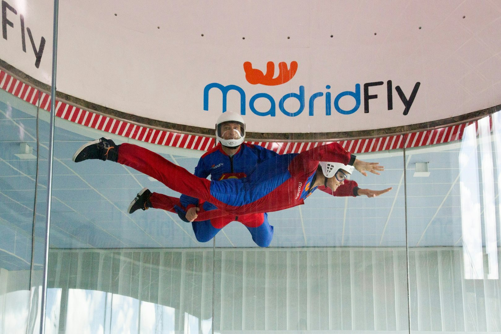 two people flying up in a vertical wind tunnel at Madrid Fly