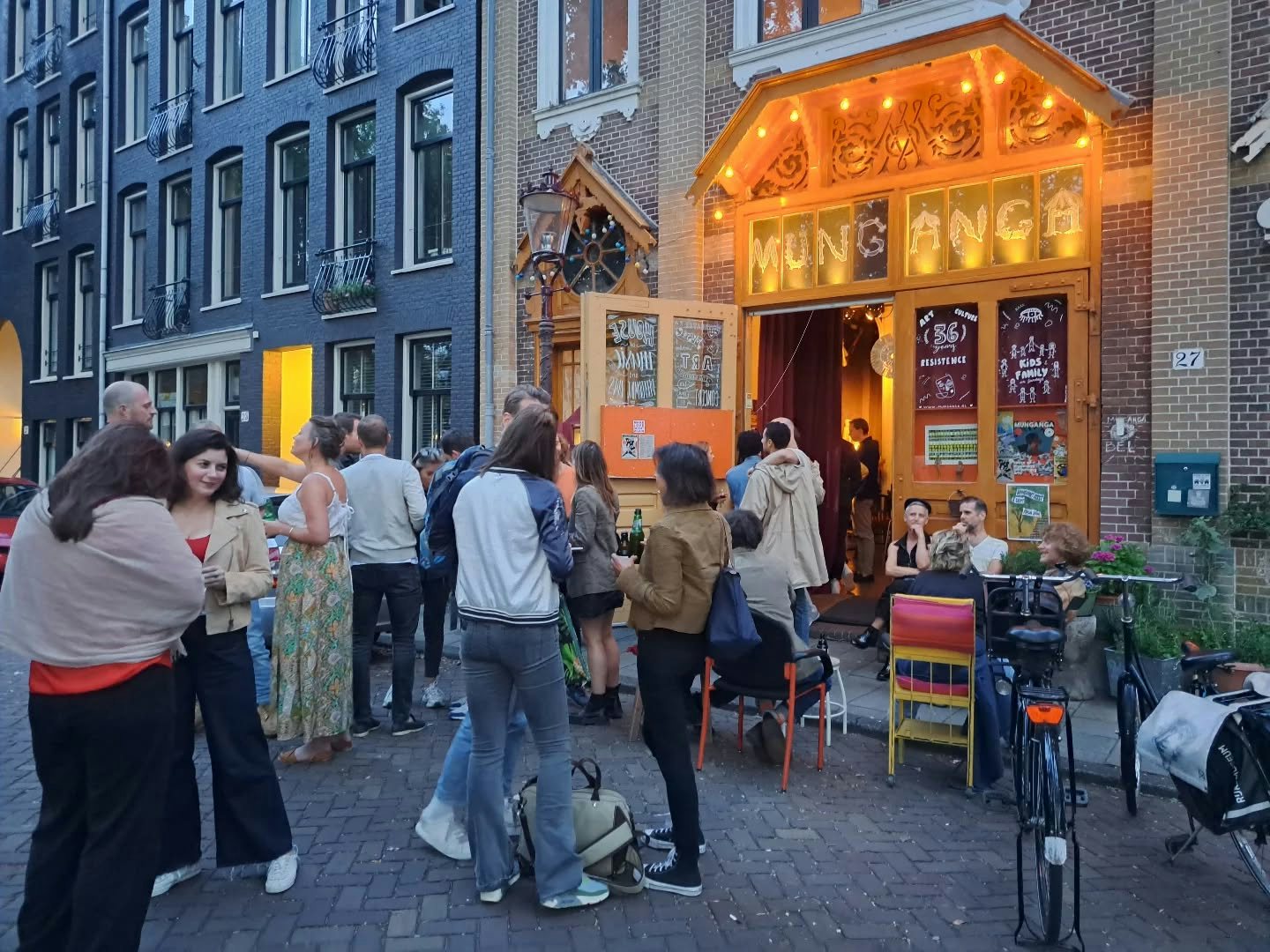 a group of people gathered outside at Teatro Munganga