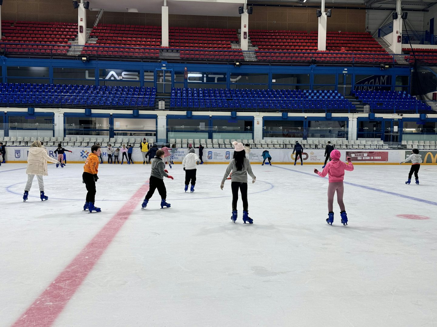 kids enjoying the ice skating rink in Madrid